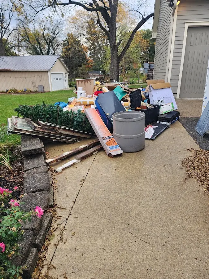 Dumpster being loaded with debris for 12 Yard Dumpster Rental in Oroville East